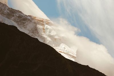 Low angle view of icicles on mountain against sky