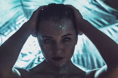 Close-up portrait of shirtless man in swimming pool