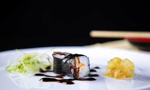 Close-up of food served on table against black background
