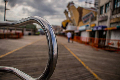 Close-up of motorcycle on road against sky