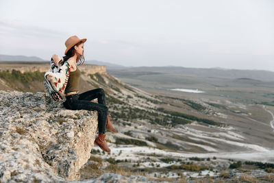 Full length of woman standing on rock