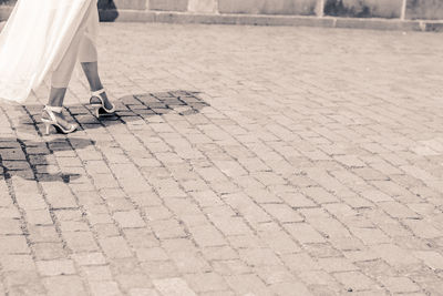 Low section of woman standing on tiled floor