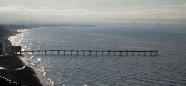 Bridge over sea against sky