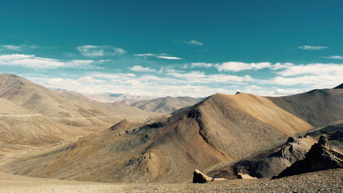 Scenic view of mountains against blue sky