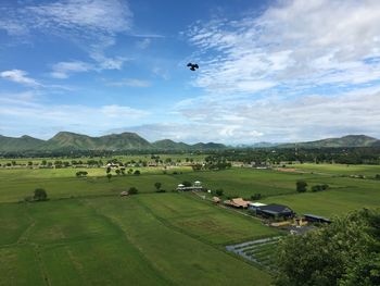 Scenic view of green landscape against sky