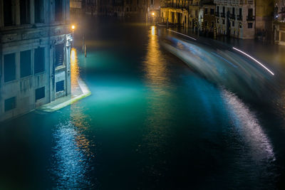 High angle view of canal in city at night