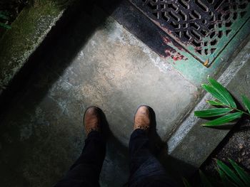 Low section of man standing by plants