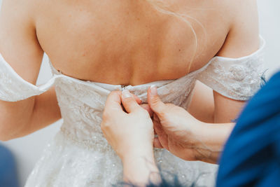 Midsection of woman wearing wedding dress