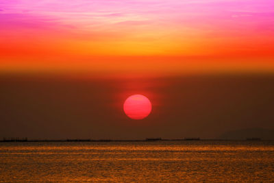 Scenic view of sea against romantic sky at sunset