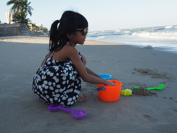 Girl with toy on beach