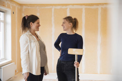 Smiling women getting ready to paint room