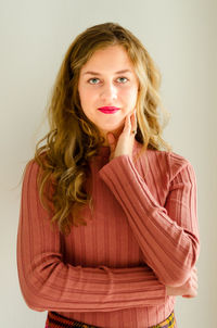 Portrait of a smiling young woman against white background