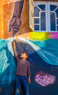 Full length of boy looking at water