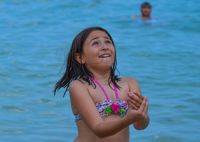 Young woman looking at swimming pool