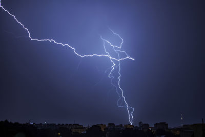 Low angle view of lightning against sky at night