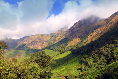 Scenic view of mountains against cloudy sky