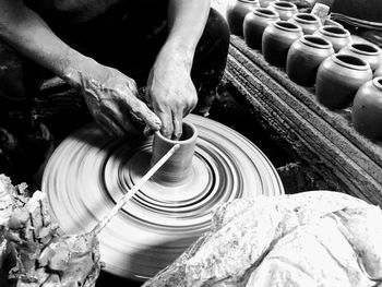 Midsection of man making pottery