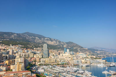 High angle view of townscape against clear blue sky