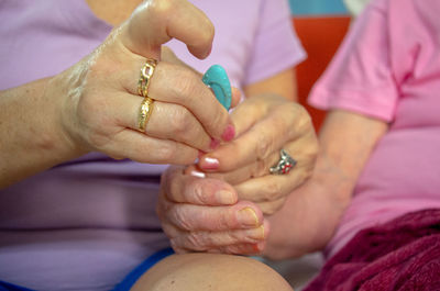 Midsection of couple holding hands