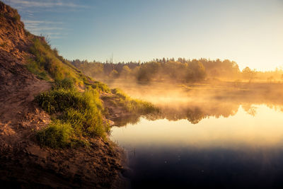 A beautiful spring landscape of a river valley with morning mist. springtime scenery of a river. 