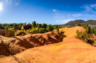 Scenic view of landscape against blue sky