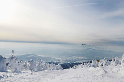 Scenic view of snowcapped landscape against sky