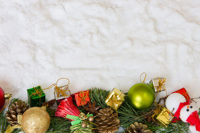 Directly above shot of christmas decorations on fake snow