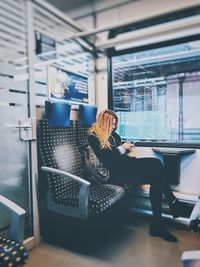 Woman sitting on escalator