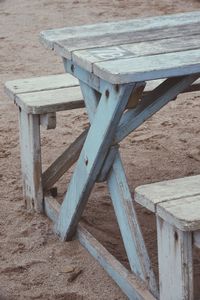 Close-up of chairs on table at beach