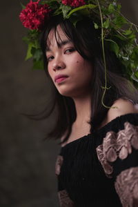 Portrait of beautiful young woman looking away