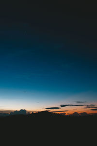 Silhouette landscape against sky at sunset