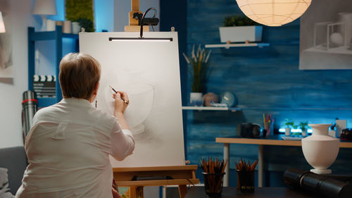 Rear view of woman working at home