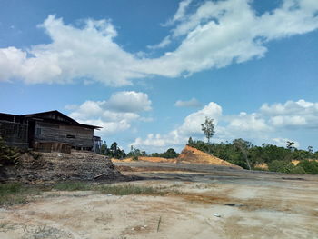 Houses on field against sky