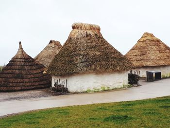 Built structure on field against sky