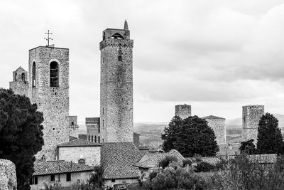 Medieval buildings in tuscany against sky