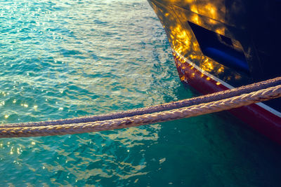 Hawser rope ship hanging over the water with glowing sunshine