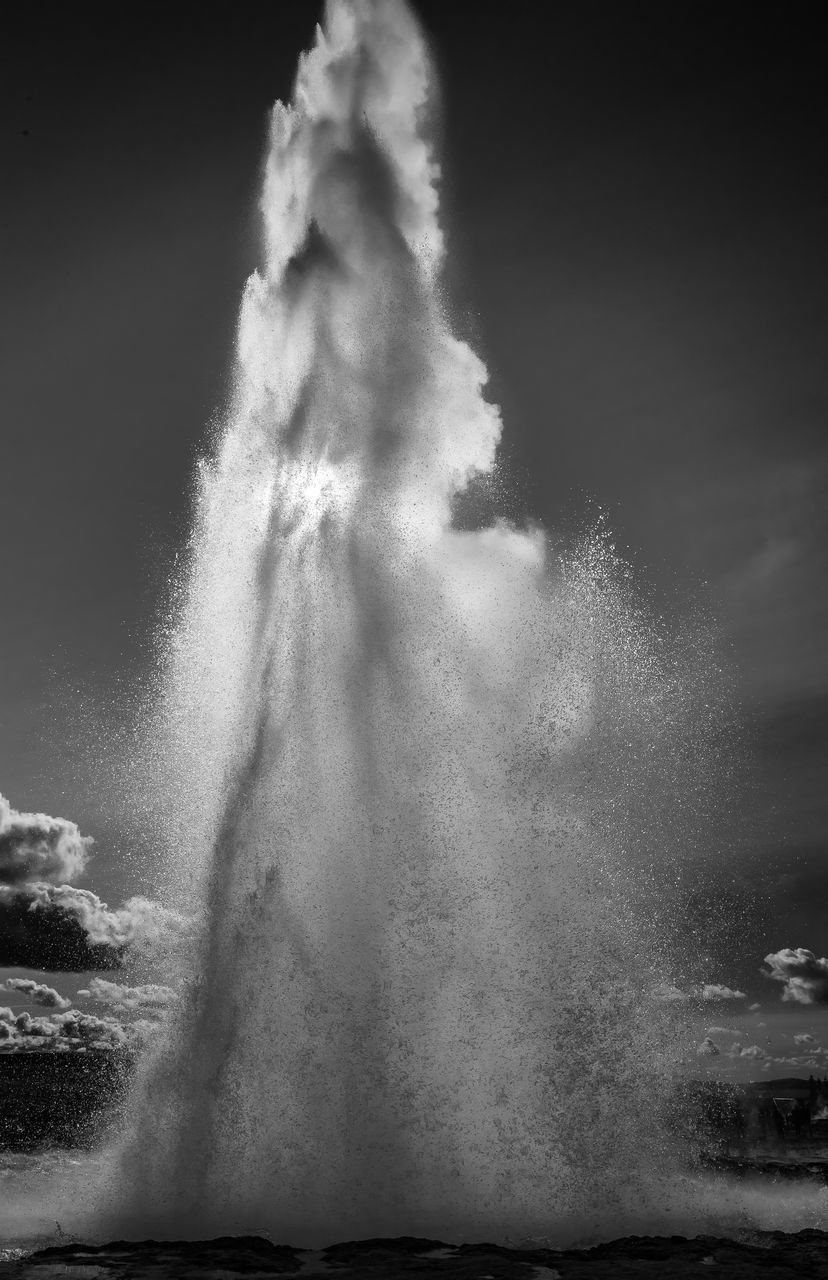 LOW ANGLE VIEW OF WATER SPLASHING AGAINST THE SKY