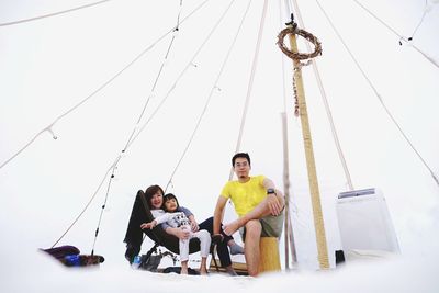 Portrait of family sitting in tent