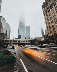Blurred motion of cars on street against one world trade center