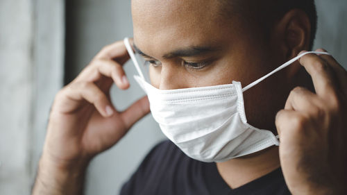 Man wearing a mask before leaving home to prevent covid 19