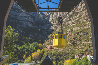 Overhead cable car against mountain