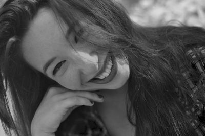 Close-up of young woman with hand in hair