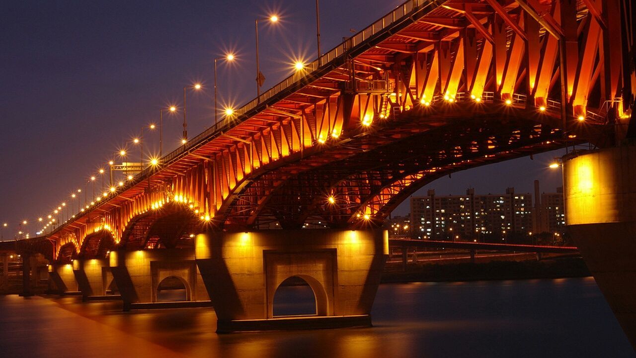 illuminated, bridge - man made structure, connection, architecture, built structure, night, engineering, river, bridge, transportation, suspension bridge, water, sky, travel destinations, city, arch bridge, famous place, reflection, international landmark, tourism