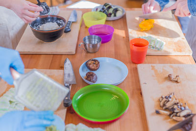 Cropped image of people preparing food at table