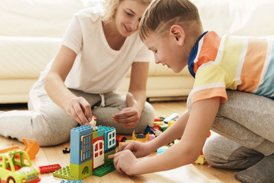 Boy playing with toy blocks at home
