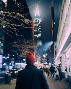 Rear view of a man in city at night