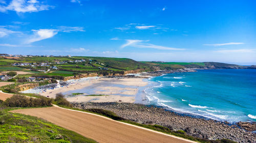 Scenic view of beach against blue sky