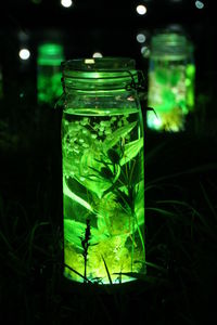 Close-up of green jar on glass