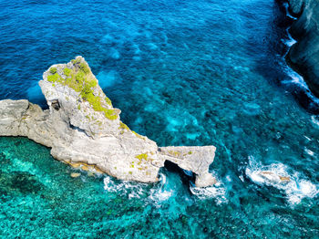 High angle view of rock in sea