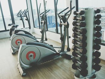 Exercise equipment on hardwood floor in gym